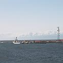 The coast guard station at the end of a LONG jetty.