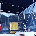 One day at anchor, we found the sun bearing down on us in the late afternoon, the rays and the heat sneaking in underneath the bimini.  So I added some zippers on three sides to attach some large see-thru shades.  The material is also Sunbrella, and is said to stop 98% of the UV while also allowing you to see through and allow a bit of breeze through.