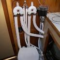 Half of the plumbing project finished.  The toilet is a Raritan PH2.  I spent the whole winter thinking about this and reading everything, and it was always the same .. "a Crittenden or a PH2" ..  "a Groco or a PH2" .. " a Lavac or a PH2".  Every conversation about good manual toilets included the PH2, so when I found one in stock at the local supplier, a decision was made.  Locating it, though, THAT was a problem.  I spent a full day doing so, but eventually found an angle and location that was comfortable to sit on, where the handle did not foul on the cabinetry or bang you on the knees when using the basin, the lid opened fully, the shutoff could still be reached, the bulkhead door opened fully and so on.  I added a water strainer as it seems as if a lot of smells are are rotting seaweed and such that got stuck in the toilet passages.