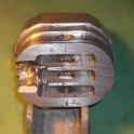 After a few hours on my little milling machine, I'm about half done.    I've produced the inner oval (that fits inside the boom), the slightly larger outer oval (that keeps the whole part from disappearing into the extrusion), the cutaway for the sail slug to slide in, the slots for the sheaves and the holes for the shaft.