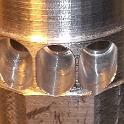 Here's the holes bored.  I used a ball endmill, so there's almost no sharp corners anywhere to snag or chafe.  The few edges that are there will be removed by a subsequent honing process (just as soon as I can find my hone!)