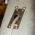 Here's an inlet for a reefing line.     To remove any chance of chafe, I've mounted a fairlead inside the boom.  To fasten it, I simply tapped the fairlead   Because I'm using stainless fasteners, there is the chance of dissimilar metal corrosion.  I've therefore installed titanium sacrificial washers between the stainless bolts and the aluminum boom.