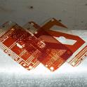 For the cheek blocks though, the kapton wouldn't do.  The blocks are not flat on the bottom, but do in fact have a bit of a radius.  This helps them sit (more) flush on a curved surface, but also means that they would sit on four points on a flat surface.   These four points could puncture the kapton, so a different solution was called for.   I have some very thick mylar film from a printed circuit board house.  This stuff is also very tough.  I cut out some gaskets and punched the mounting holes.  Should be fine.
