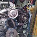 Here's a pic of my engine compartment, shortly after the installation of the new wiring harness.  Part of the project was a quick clean of the entire area, as it was covered in a thin layer of black .. soot?  I thought it was soot; it was fine, black and in the area of a diesel engine.  What else could it be?  Inside the blue circle is some of the blackness, not yet cleaned.  In the blue rectangle is some teak and oak that just didn't want to get clean.  But I could not figure out where it was coming from!  There was no exhaust leak, nothing coming out of the intake, no smoke when running, nothing.   I considered carbon dust from the alternator brushes, but there was far too much blackness for that to seem likely, and in places that just didn't seem possible.  And there was something else a bit odd; the "soot" didn't get a guy as dirty as I thought it should, my hands washing up just fine.  So where was the "soot" coming from?  Google to the rescue, and the discovery of a number of posts about belts being chewed up and spewing rubber dust.  A close examination of the pulleys showed this to be very likely, as the next frame will show, so off they came.